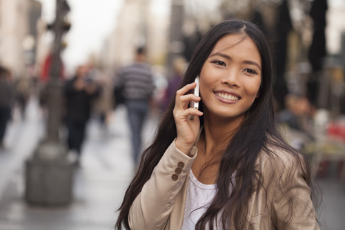 Filipino lady with phone in city